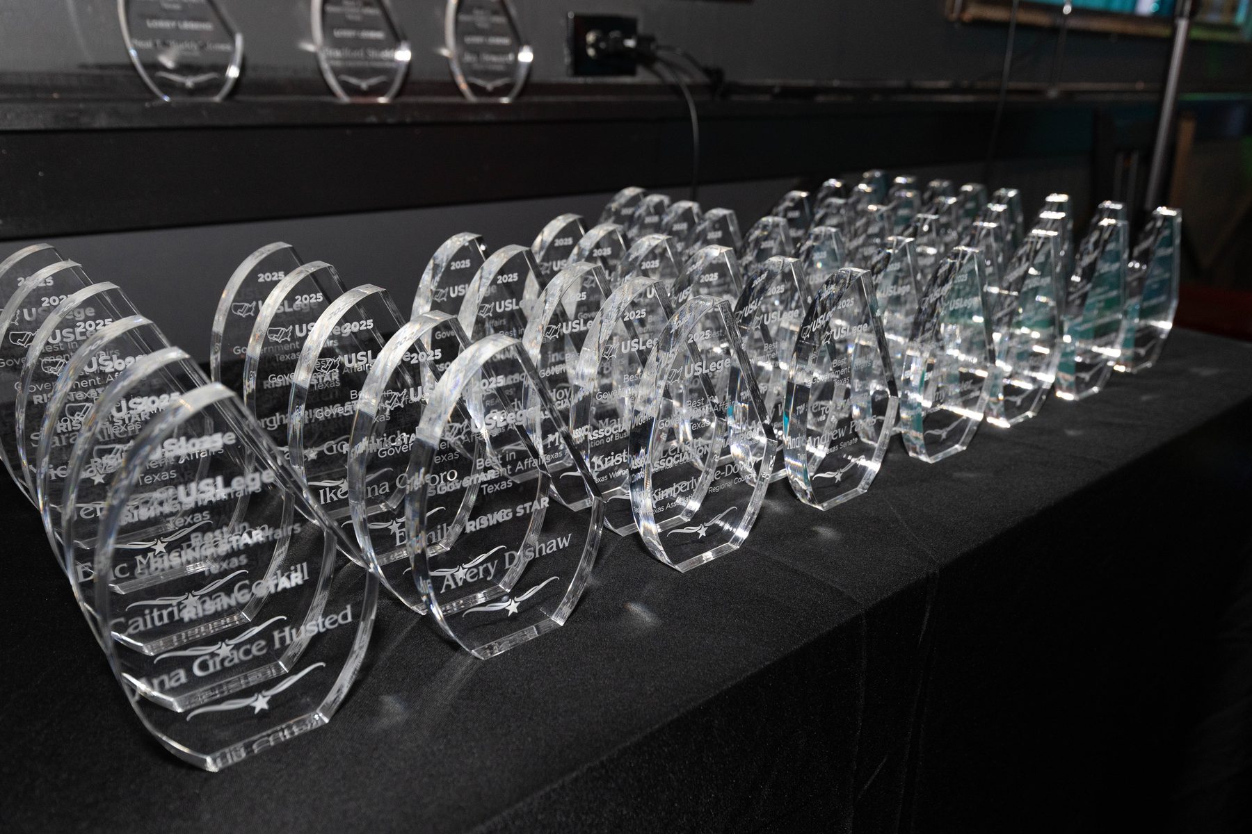 Rows of engraved crystal Best in Government Affairs awards at the 2025 Texas ceremony