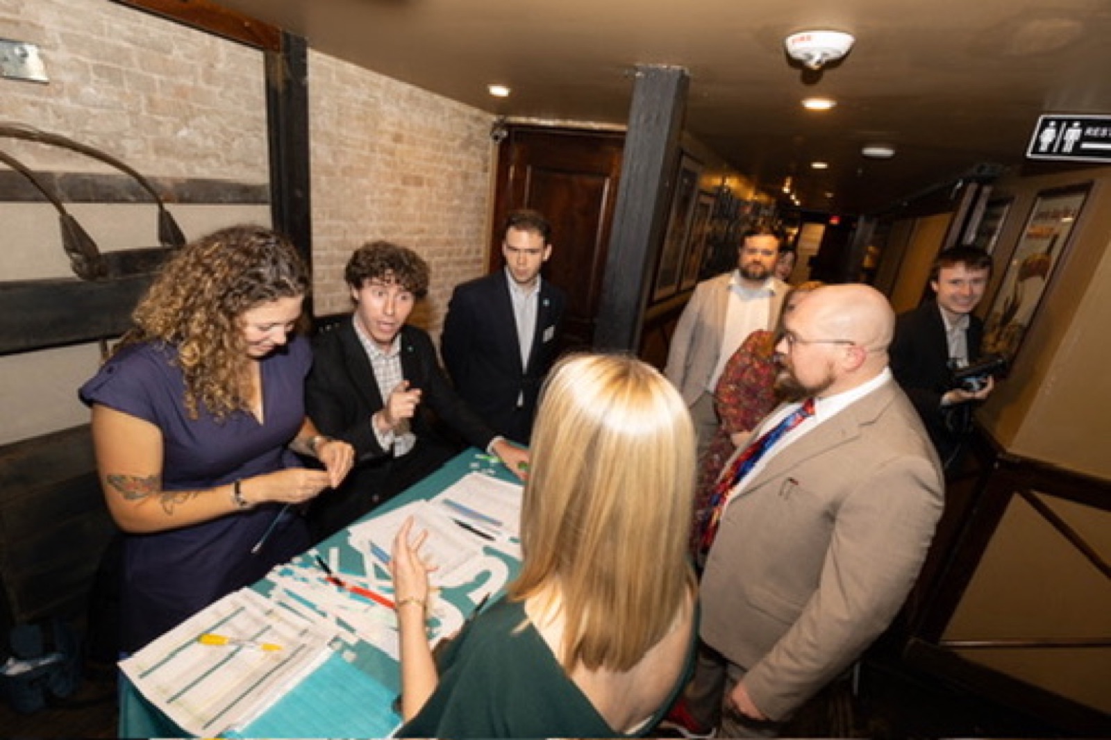 Teammates checking guests in at a USLege happy hour